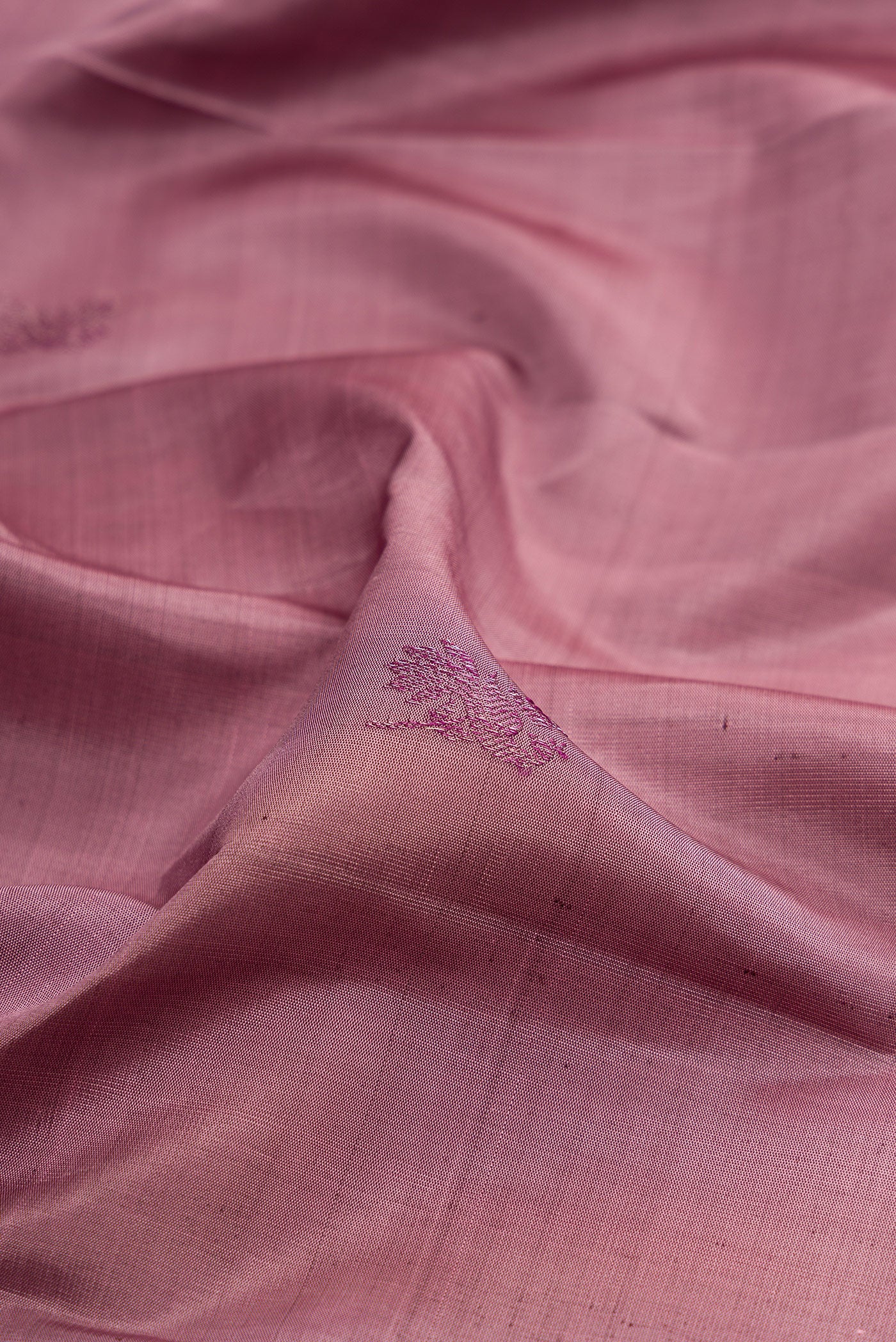 Close up of Mauve Kanchipuram Silk Saree with Zari Butta on the body and Fancy Border.  displaying folds