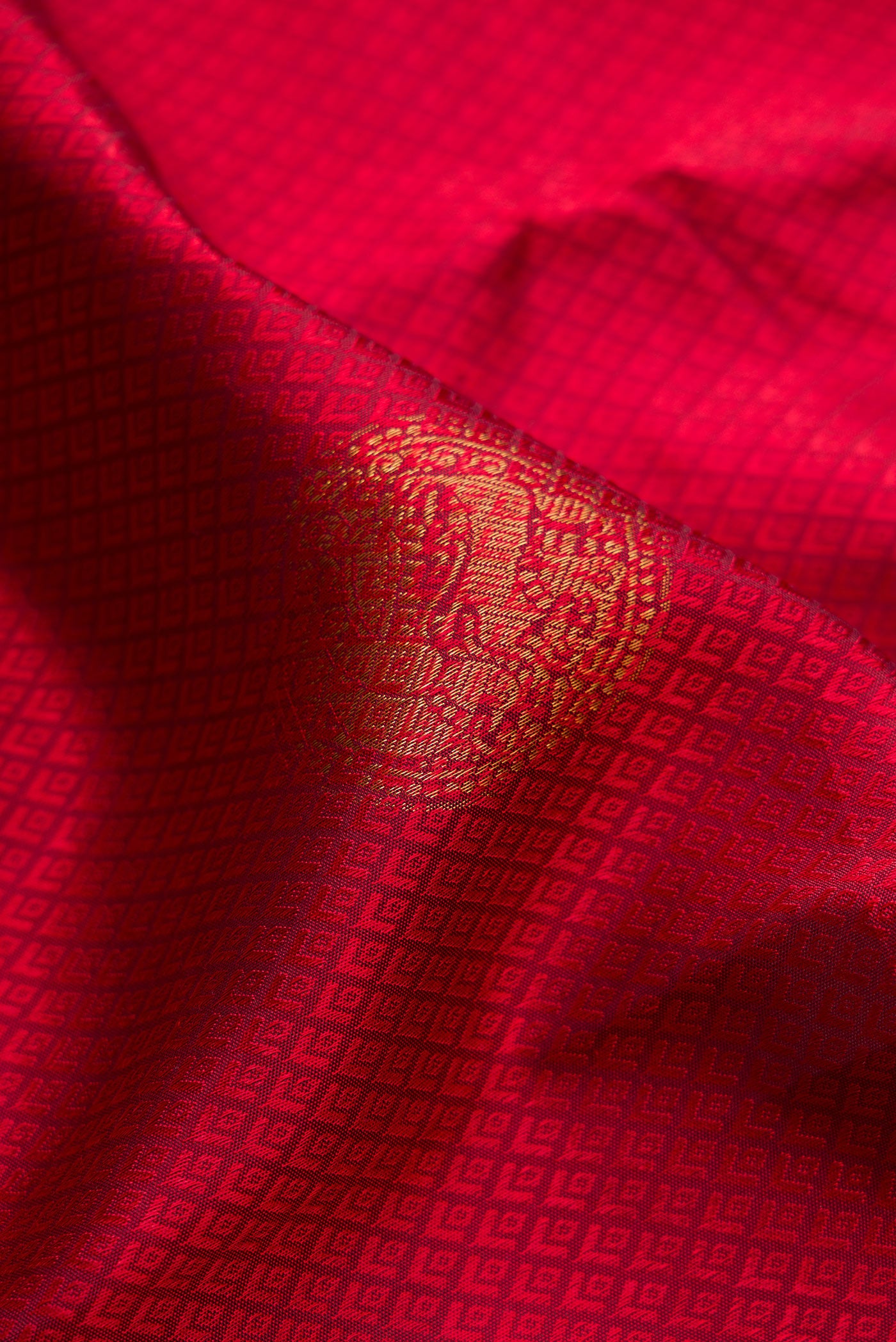Close up of Maroon Kanjivaram Silk Saree with Jacquard With Zari Butta on the body and Zari Border.  displaying folds