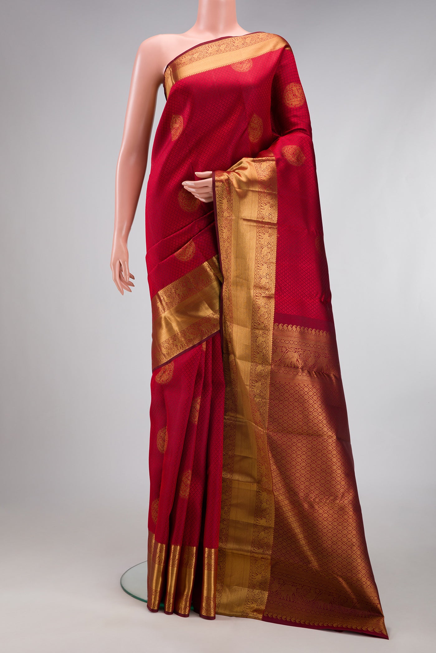 Maroon Kanjivaram Silk Saree with Jacquard With Zari Butta on the body and Zari Border.  displayed on a mannequin