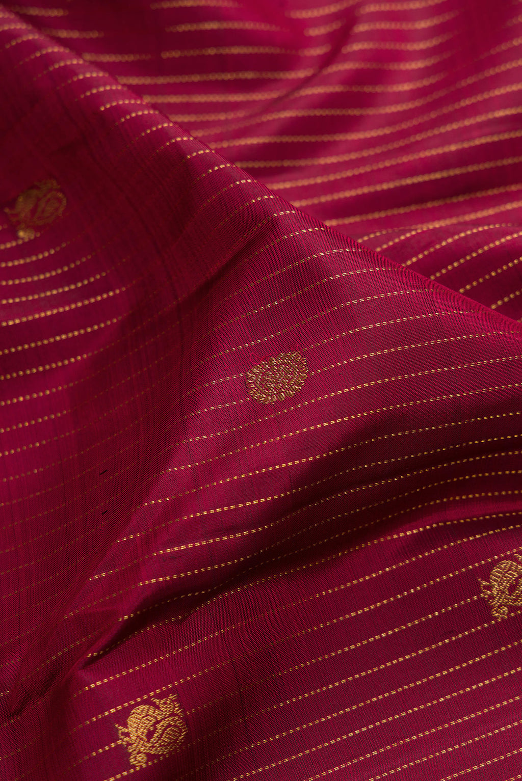 Close up of Pure Silk Red Kanjivaram Saree with Stripes on the body and Zari Border.  displaying folds