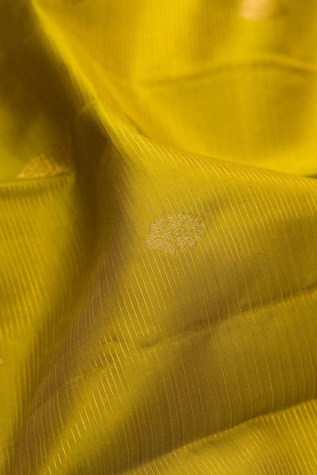 Close up of Mehandi Green Kanjivaram Silk Saree with Stripes on the body and Zari Border.  displaying folds