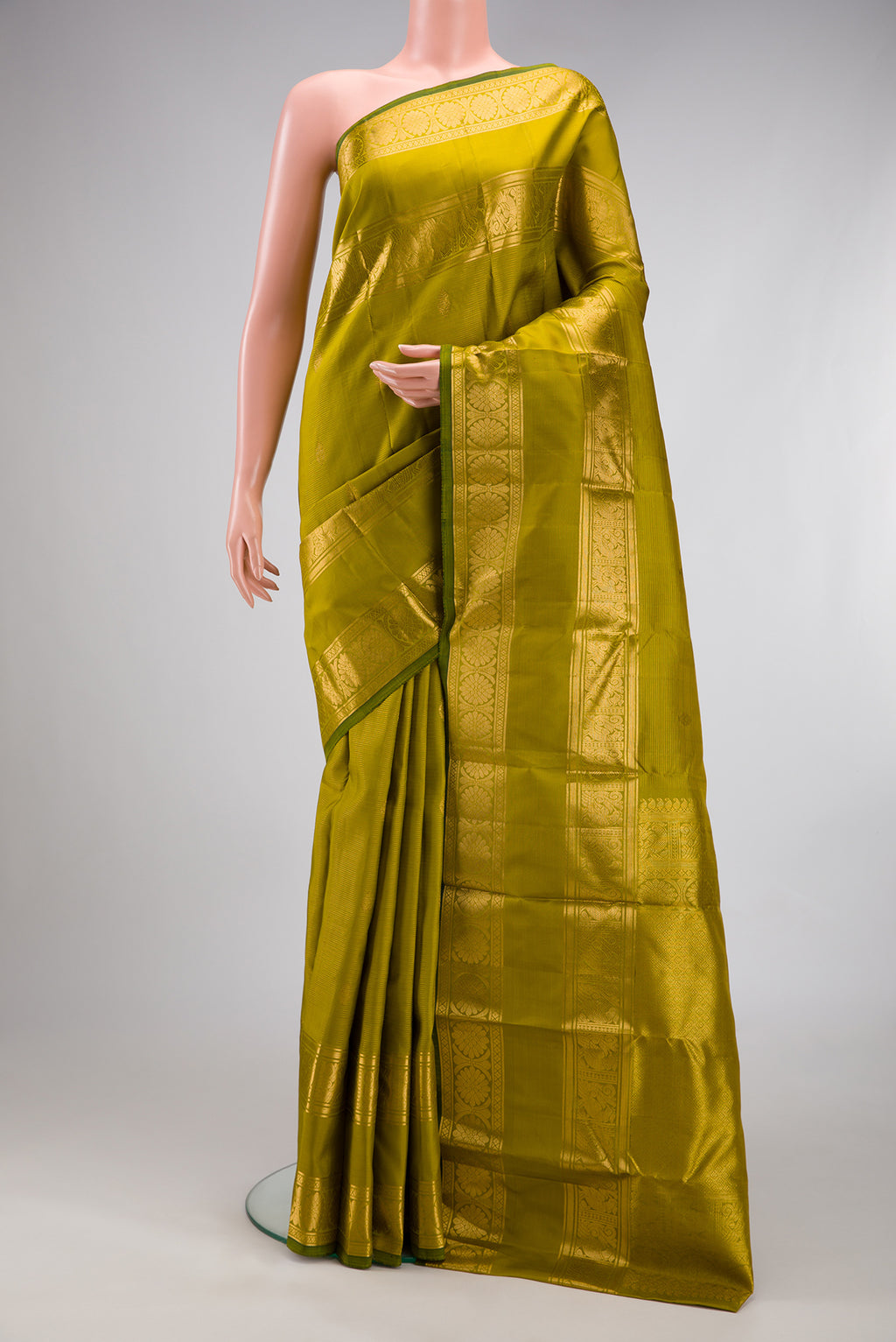 Mehandi Green Kanjivaram Silk Saree with Stripes on the body and Zari Border.  displayed on a mannequin