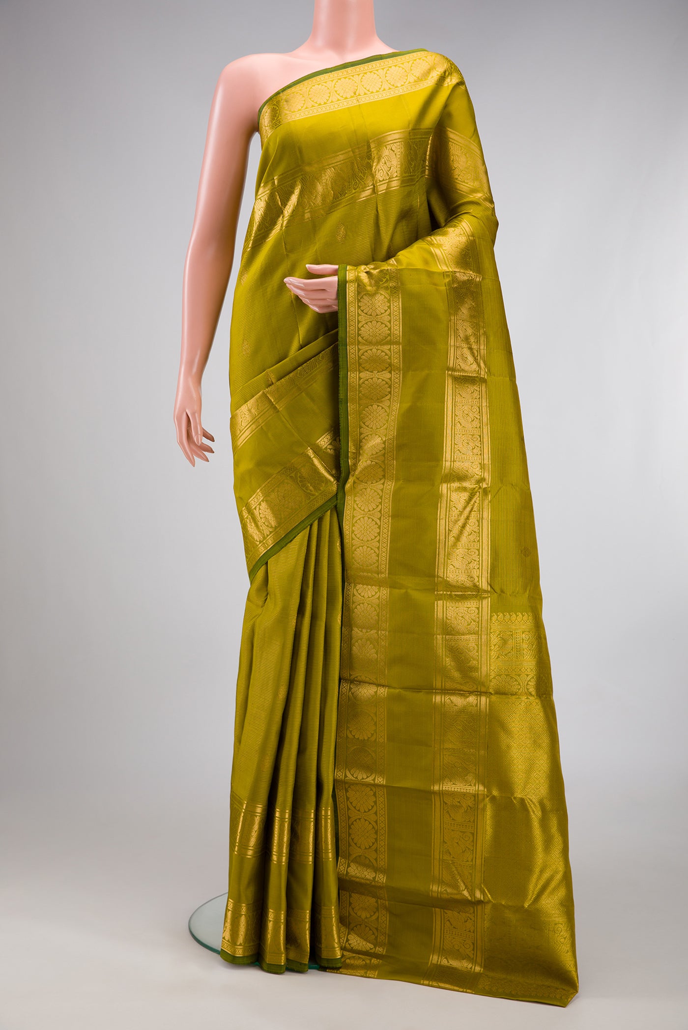 Mehandi Green Kanjivaram Silk Saree with Stripes on the body and Zari Border.  displayed on a mannequin