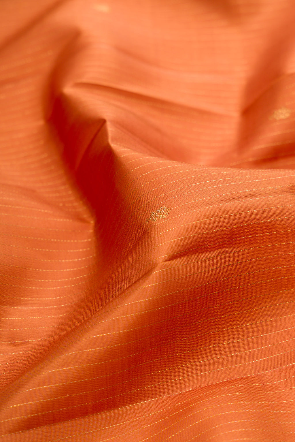 Close up of Mustard Kanjivaram Silk Saree with Stripes on the body and Zari Border.  displaying folds