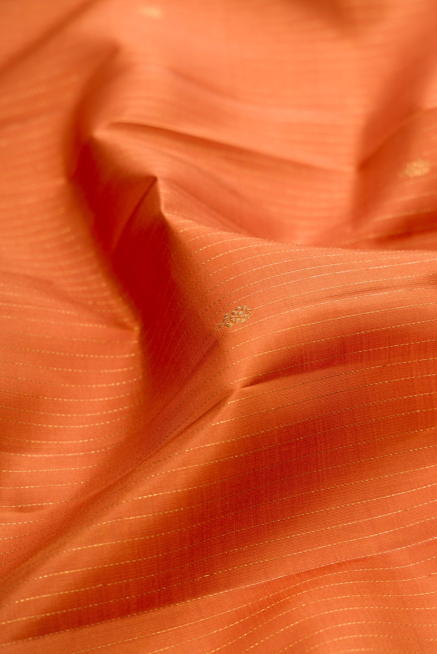 Close up of Mustard Kanjivaram Silk Saree with Stripes on the body and Zari Border.  displaying folds