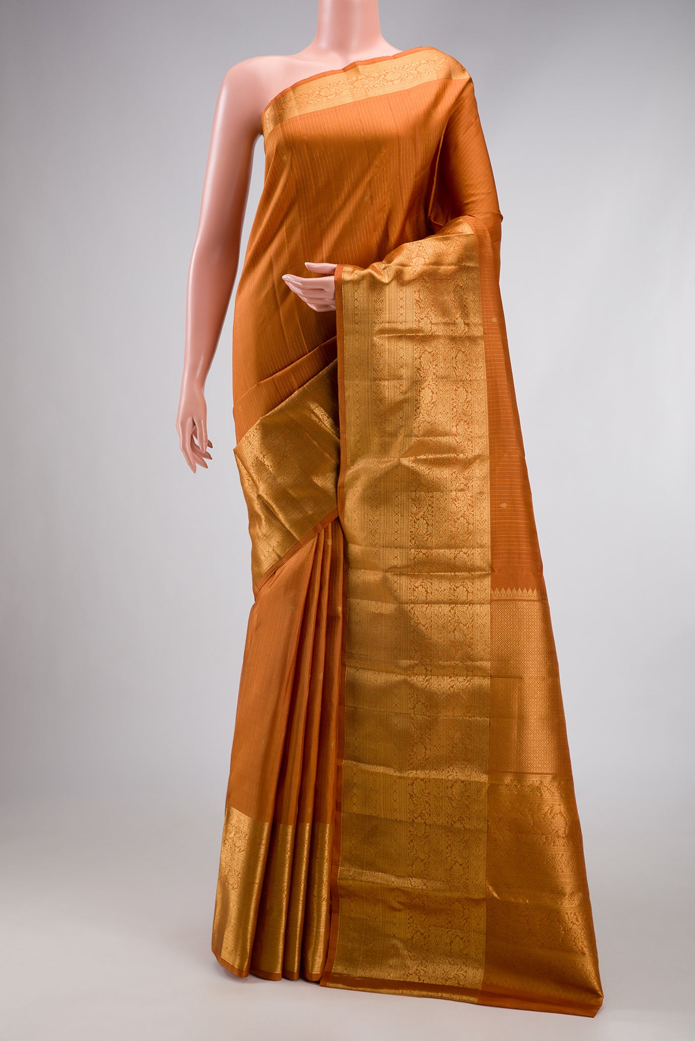 Mustard Kanjivaram Silk Saree with Stripes on the body and Zari Border.  displayed on a mannequin