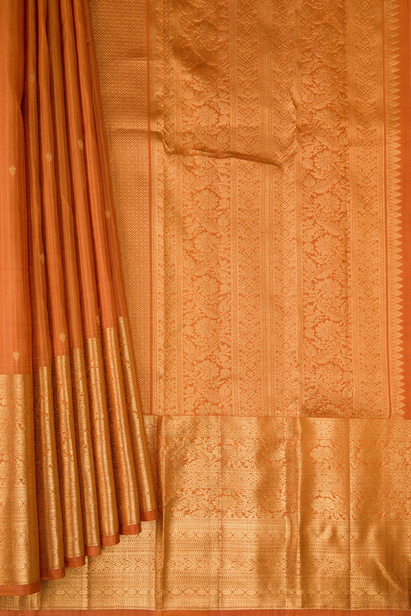 Pleats and pallu of Mustard Kanjivaram Silk Saree with Stripes on the body and Zari Border. 