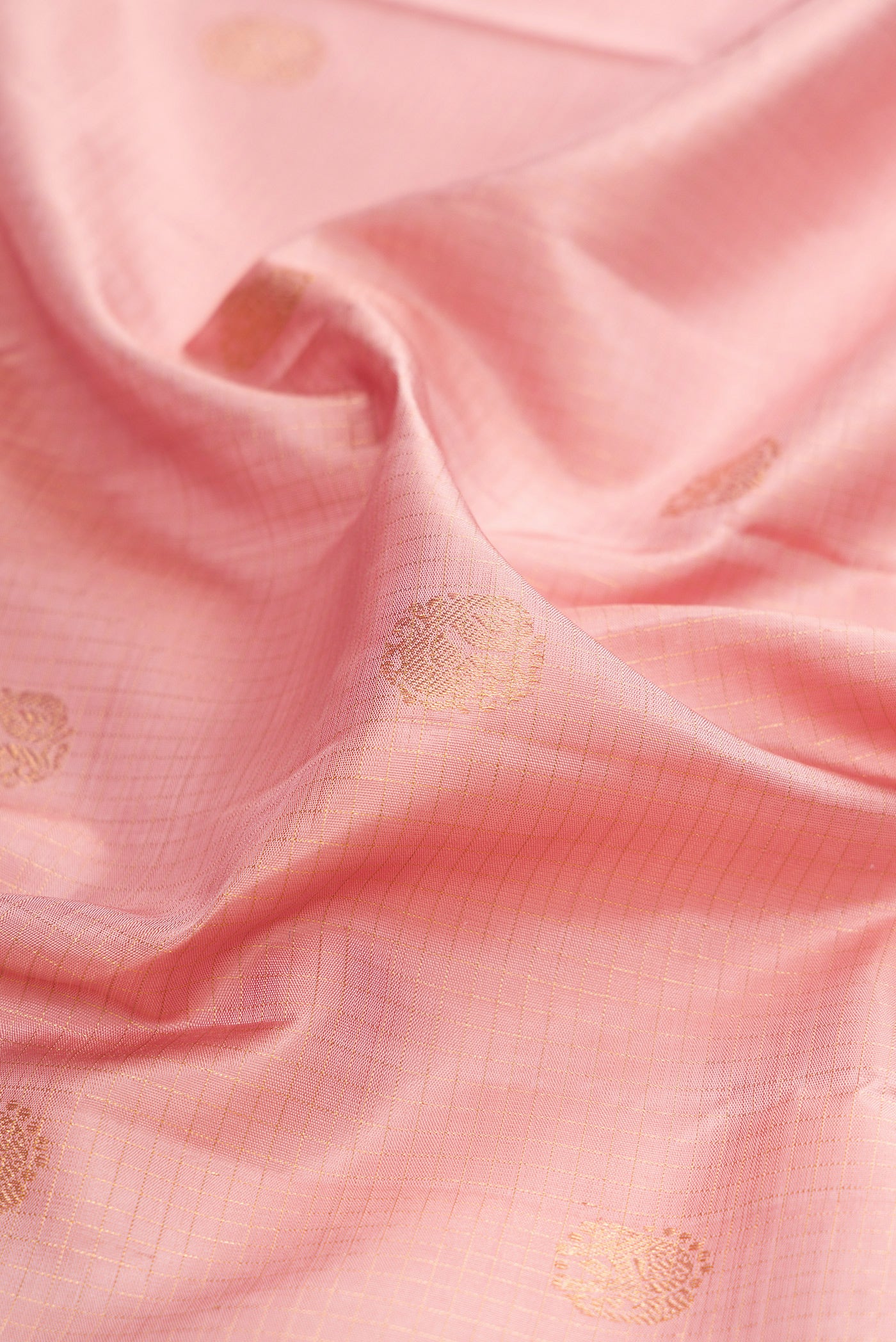 Close up of Rose pink Kanjivaram Silk Saree with Checked design on the body and Zari Border.  displaying folds