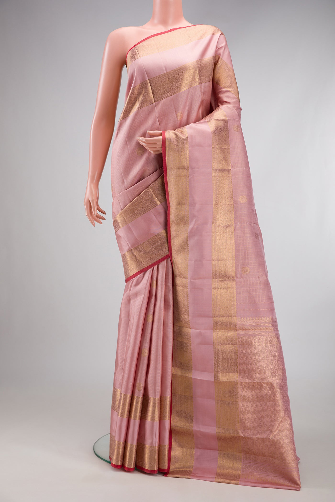 Rose pink Kanjivaram Silk Saree with Checked design on the body and Zari Border.  displayed on a mannequin