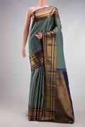 Grey Kanjivaram Silk Saree with Checked design on the body and Fancy Border.  displayed on a mannequin