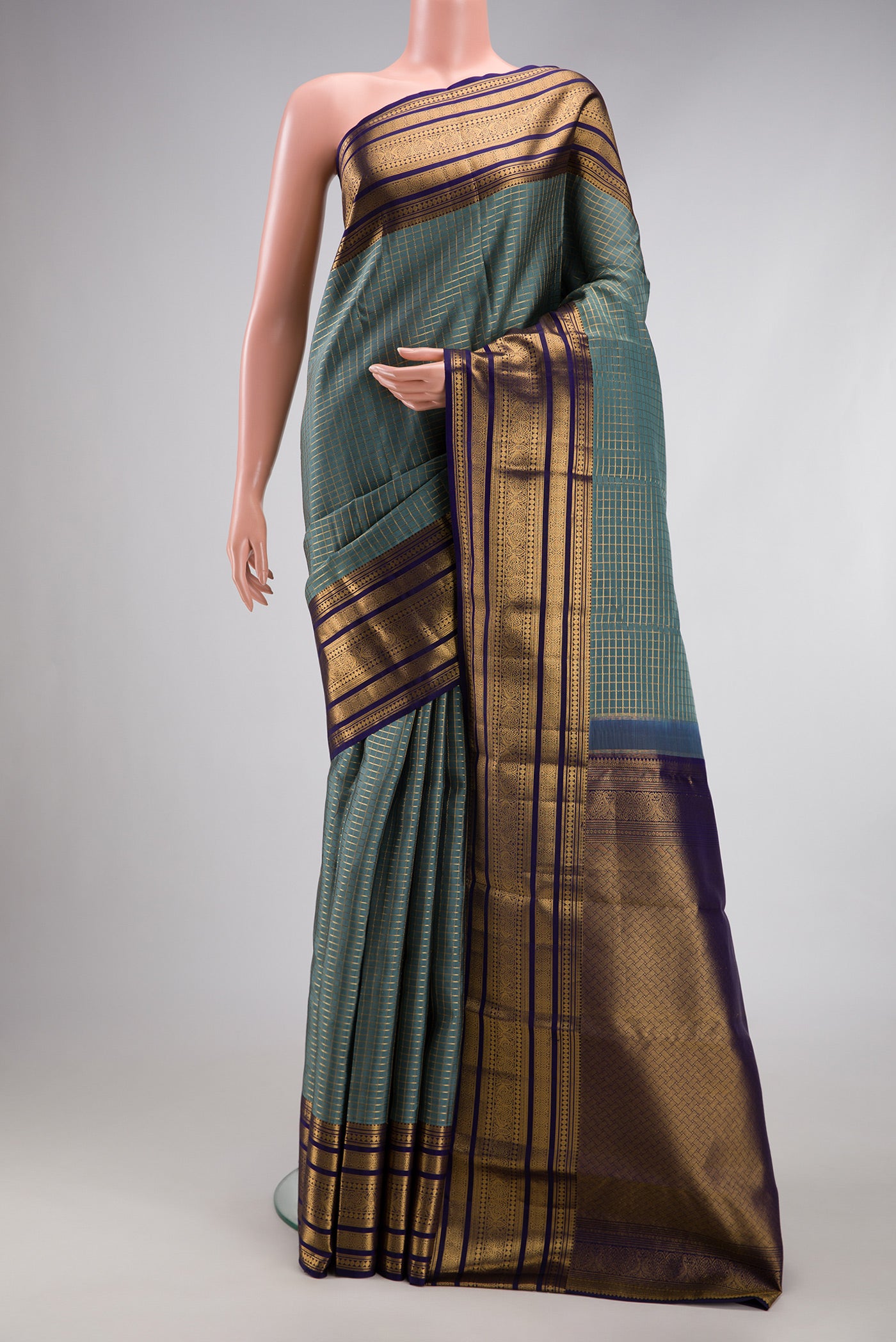 Grey Kanjivaram Silk Saree with Checked design on the body and Fancy Border.  displayed on a mannequin
