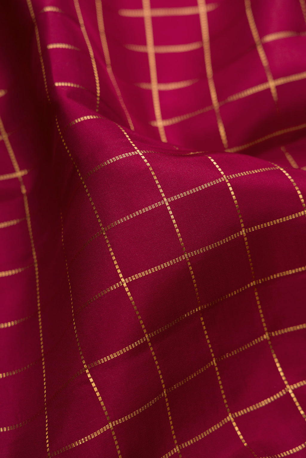 Close up of Maroon Kanjivaram Silk Saree with Checked design on the body and Zari Border.  displaying folds