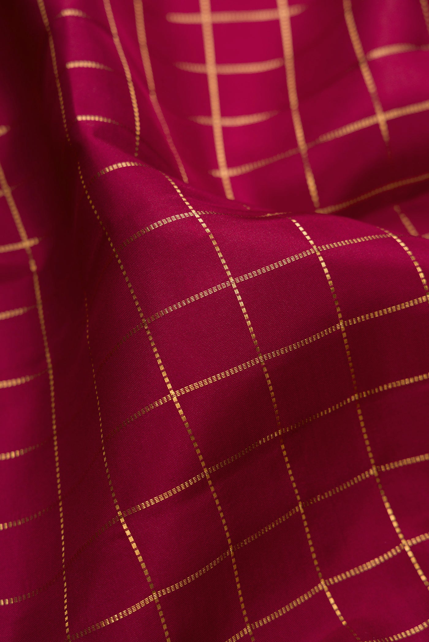 Close up of Maroon Kanjivaram Silk Saree with Checked design on the body and Zari Border.  displaying folds