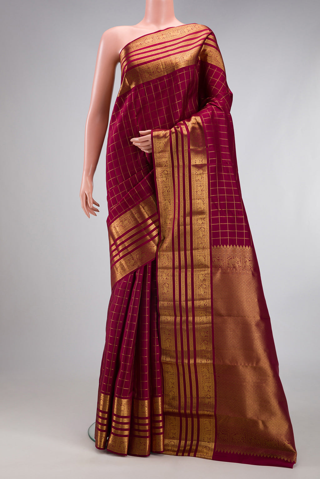 Maroon Kanjivaram Silk Saree with Checked design on the body and Zari Border.  displayed on a mannequin