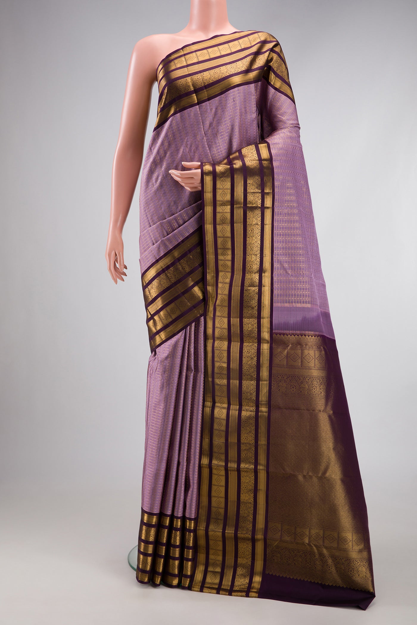 Lavender Dual Tone Kanjivaram Silk Saree with Checked design on the body and Fancy Border.  displayed on a mannequin