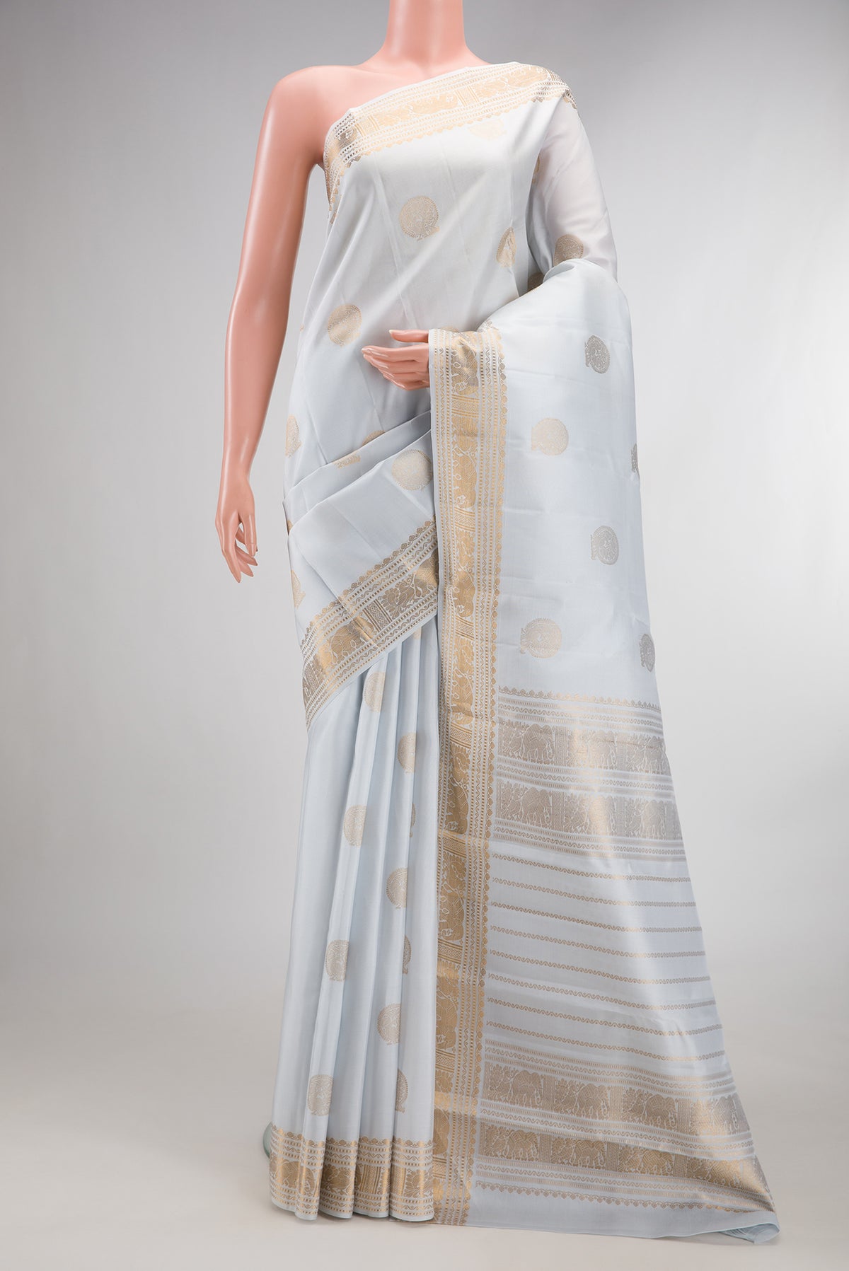 Pure Silk Light Blue Kanjivaram Saree with Zari Butta on the body and Zari Border.  displayed on a mannequin