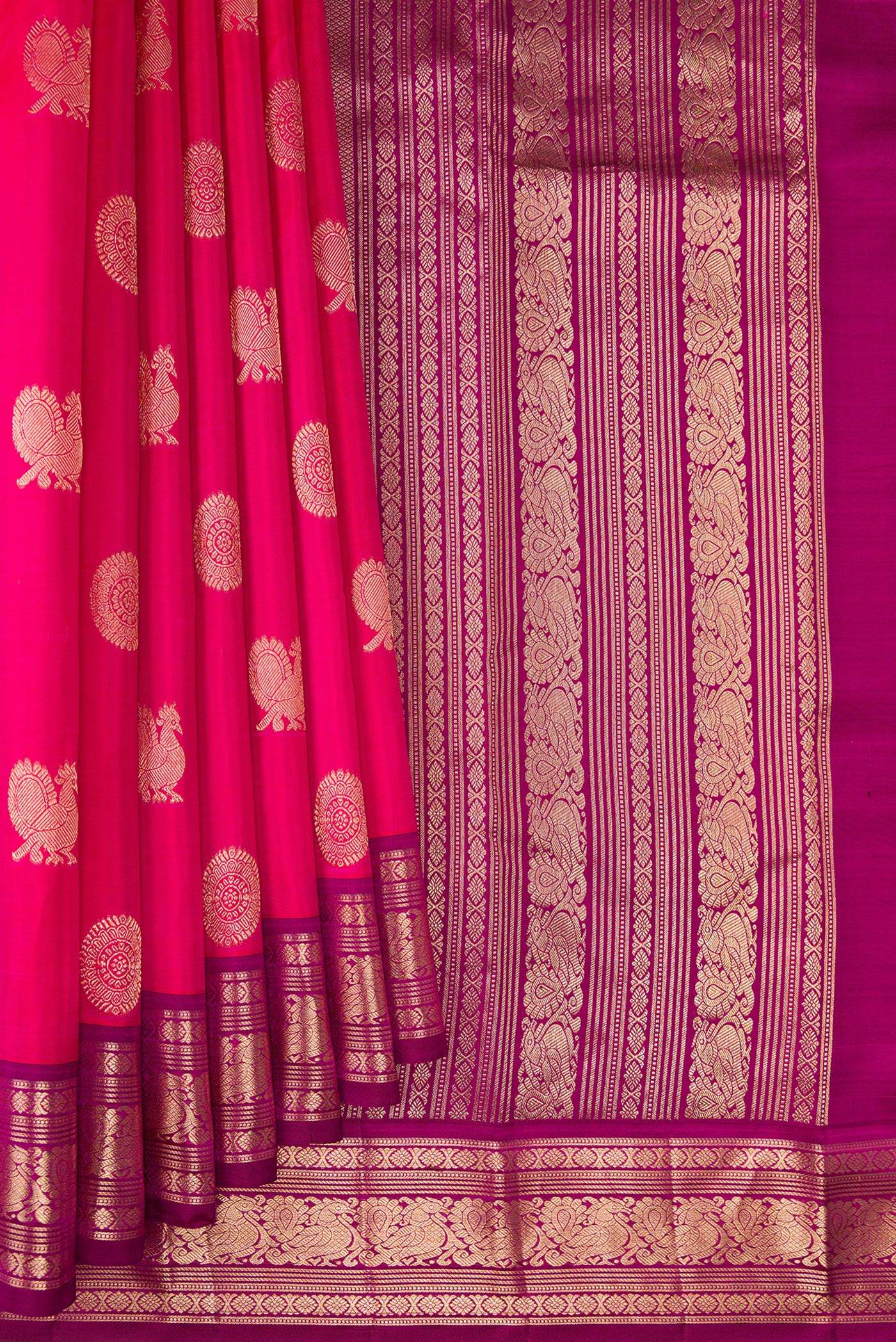 Pleats and pallu of Dark Pink Kanjivaram Silk Saree with Zari Butta on the body and Zari Border. 