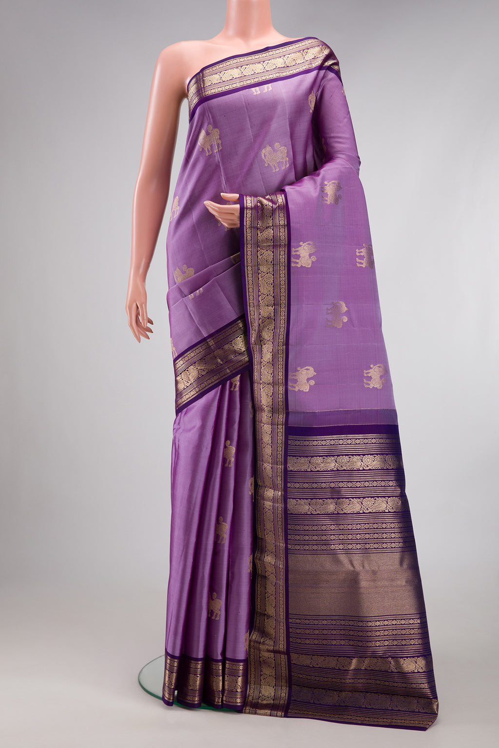 Lavender Kanjivaram Silk Saree with Zari Butta on the body and Zari Border.  displayed on a mannequin