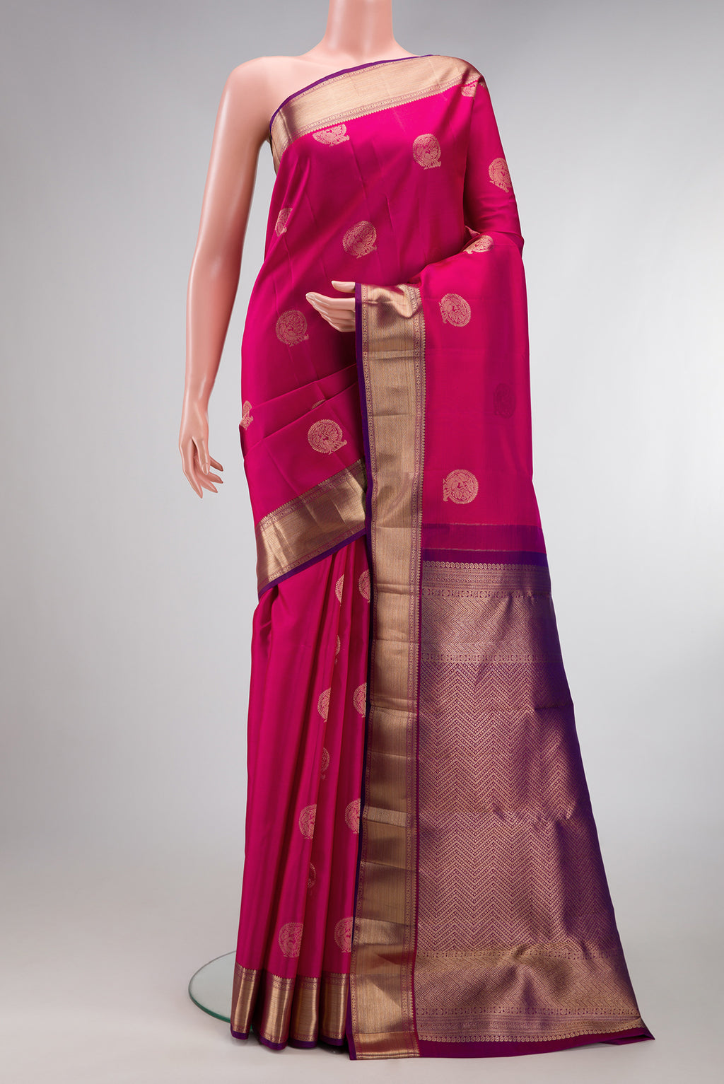 Dark Pink Kanjivaram Silk Saree with Zari Butta on the body and Zari Border.  displayed on a mannequin