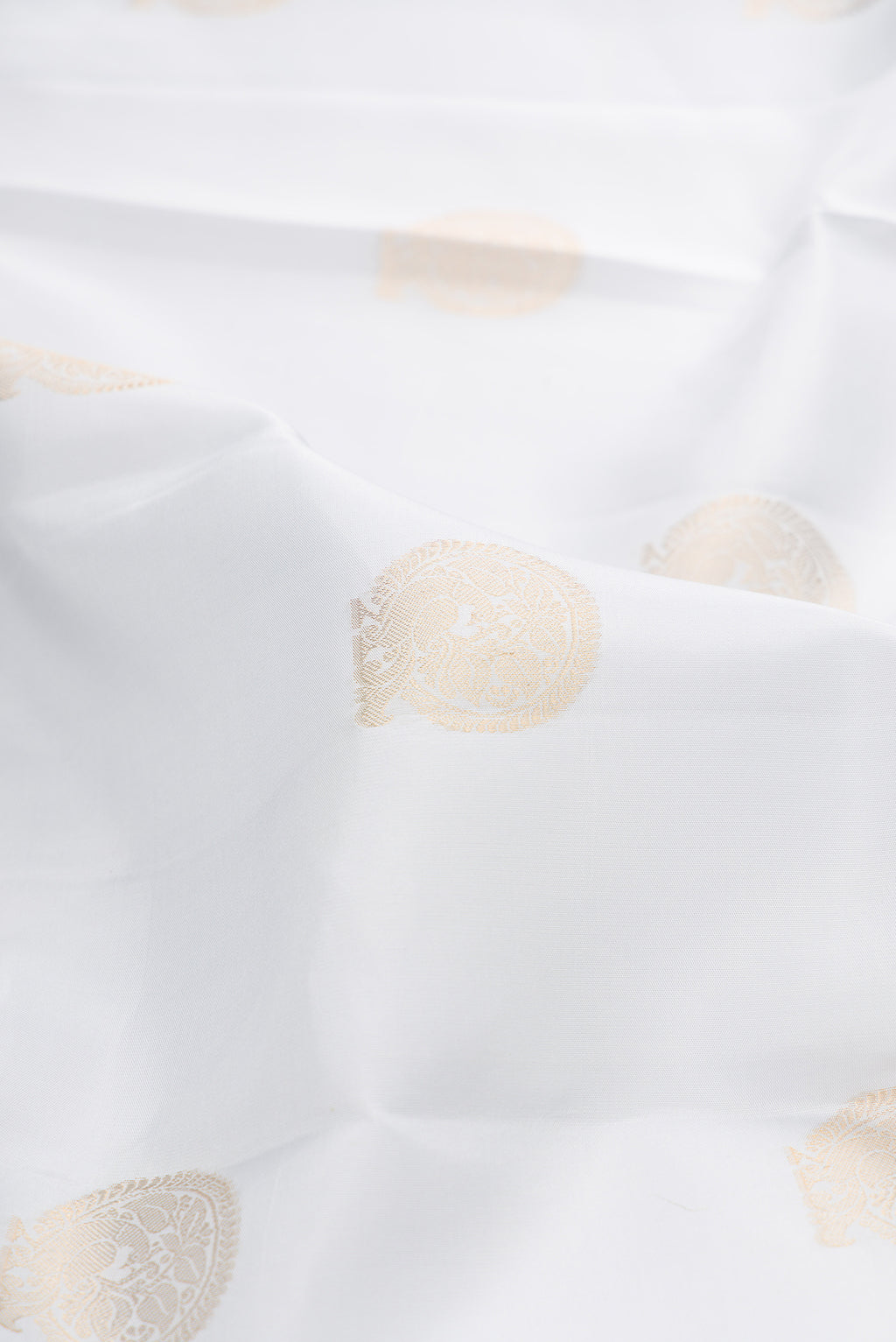 Close up of Grey Kanjivaram Silk Saree with Zari Butta on the body and Zari Border.  displaying folds