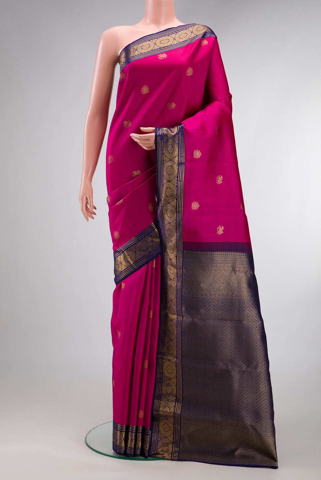 Dark Pink Kanchipuram Silk Saree with Zari Butta on the body and Zari Border.  displayed on a mannequin