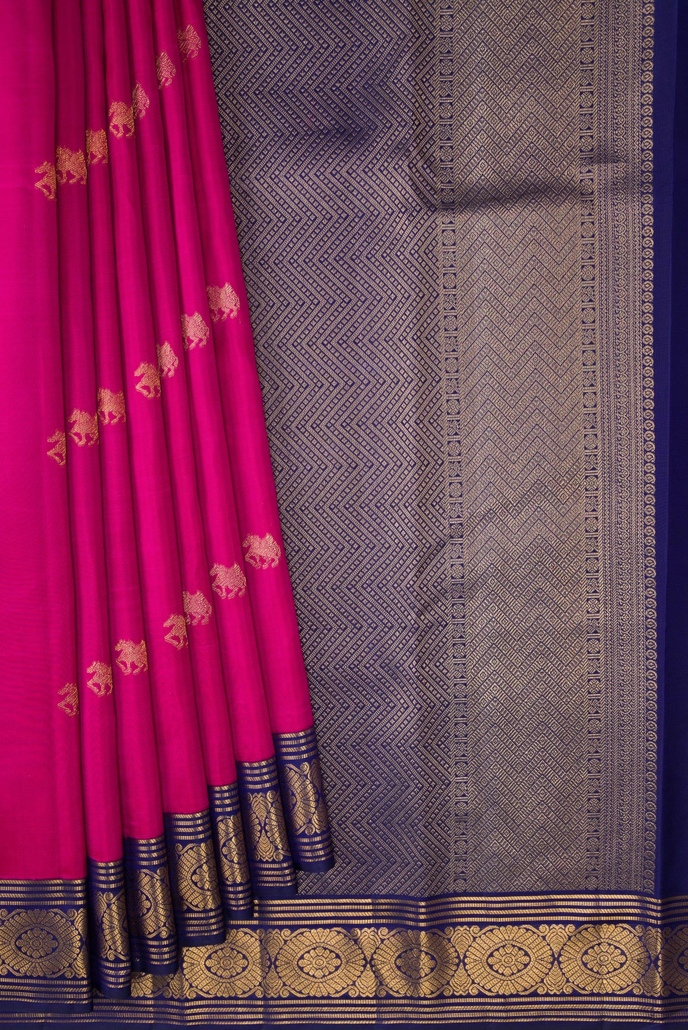Pleats and pallu of Dark Pink Kanchipuram Silk Saree with Zari Butta on the body and Zari Border. 