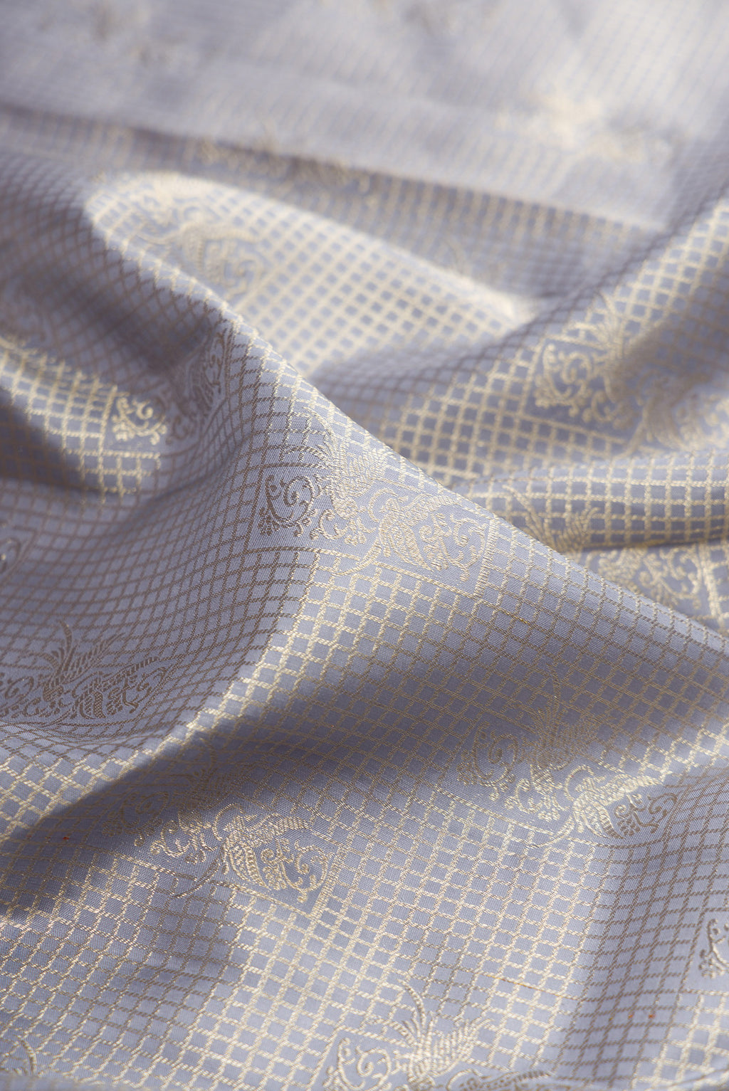 Close up of Grey Kanchipuram Silk Saree with Zari Brocade on the body and Zari Border.  displaying folds