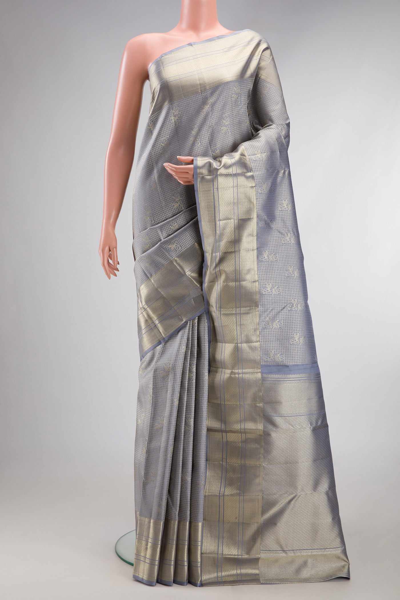 Grey Kanchipuram Silk Saree with Zari Brocade on the body and Zari Border.  displayed on a mannequin
