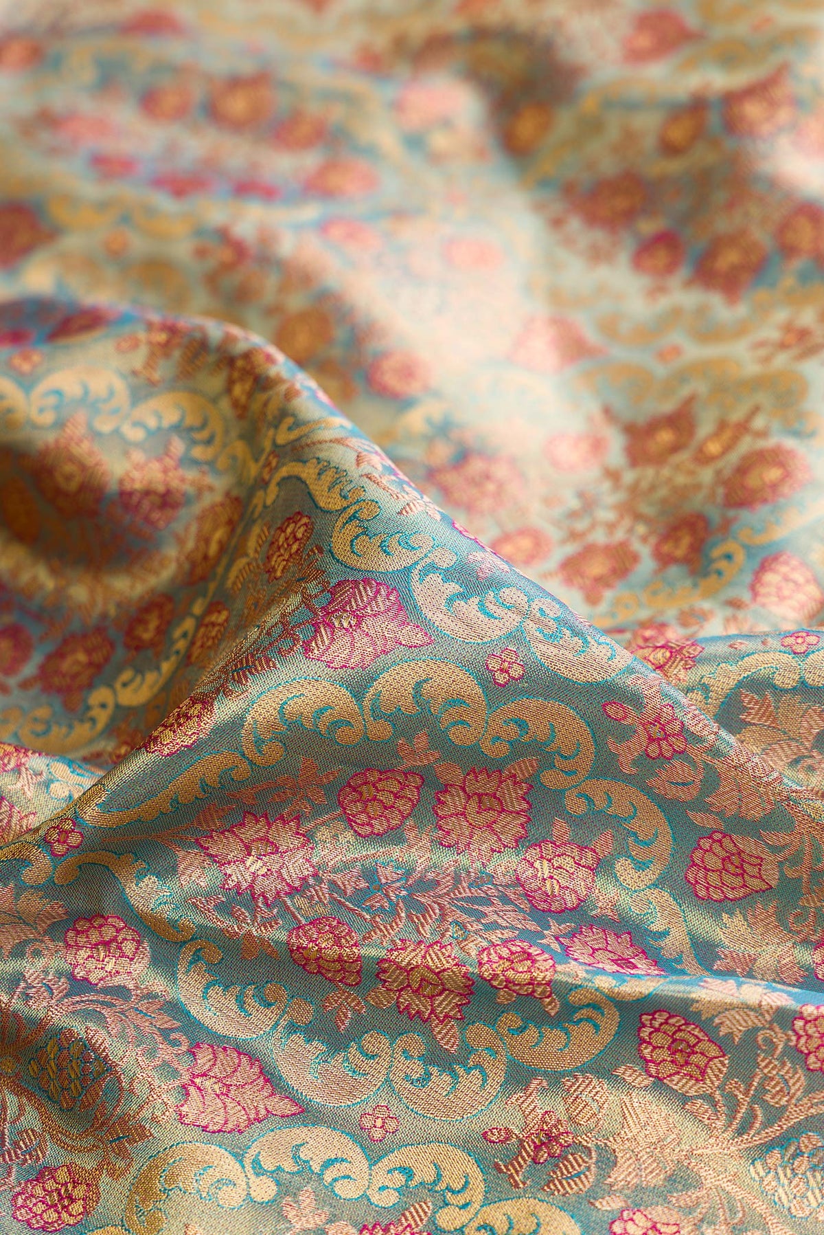 Close up of Sky Blue Dual Tone Kanchipuram Tissue Saree with Zari Brocade on the body and Zari Border.  displaying folds