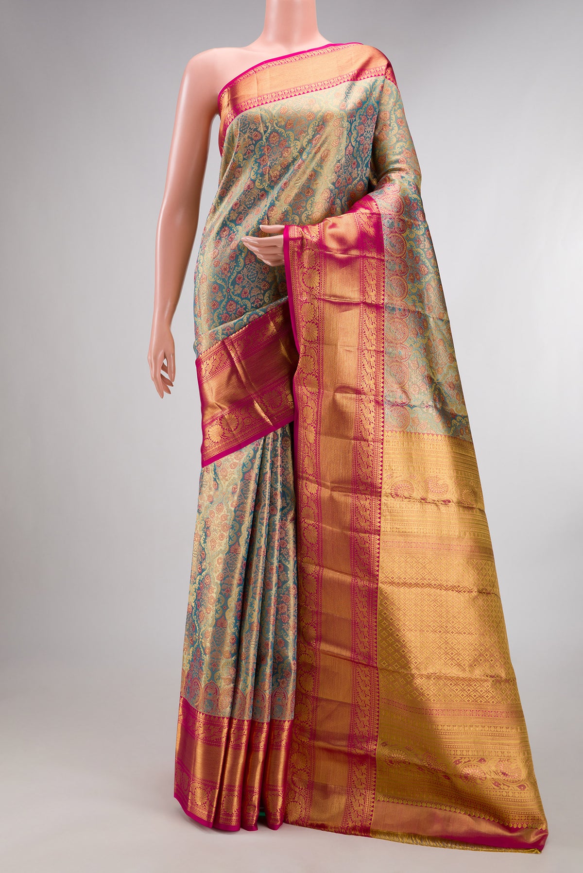 Sky Blue Dual Tone Kanchipuram Tissue Saree with Zari Brocade on the body and Zari Border.  displayed on a mannequin
