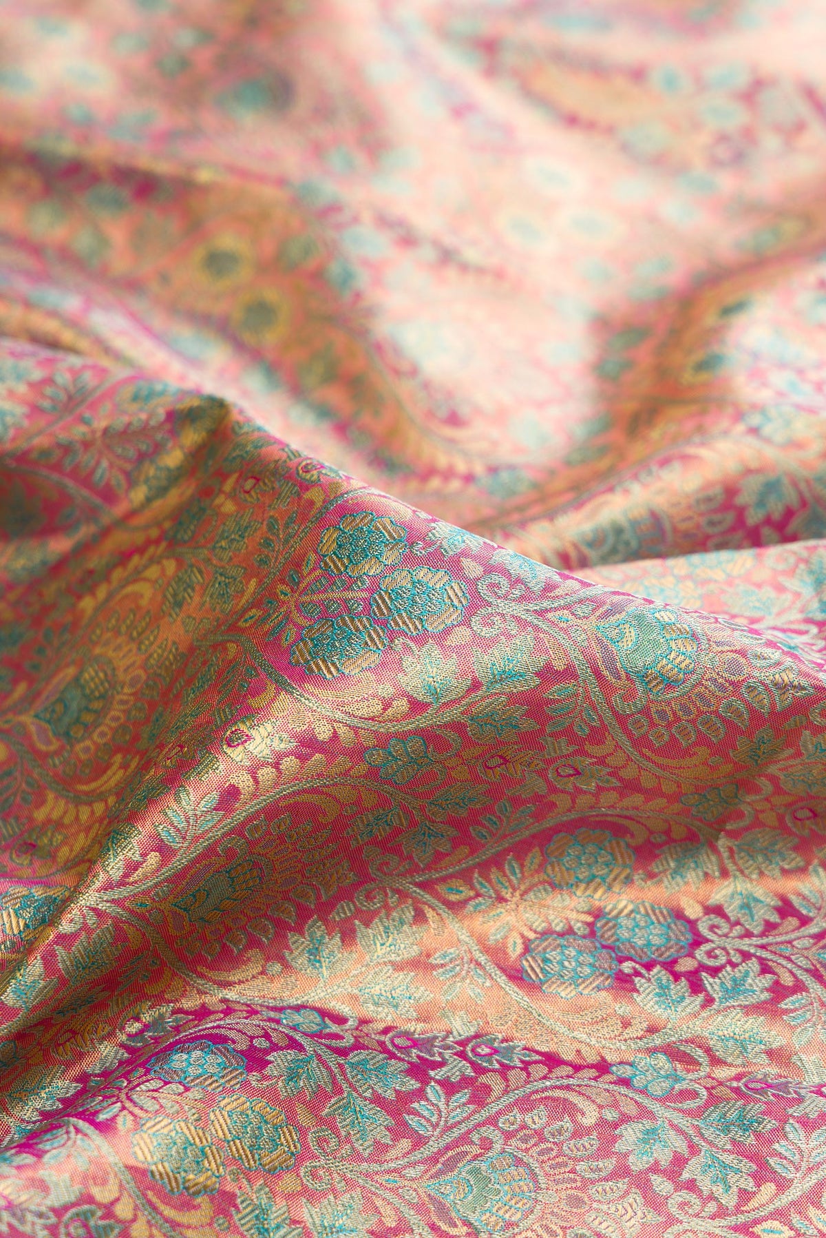 Close up of Pure Silk Pink Kanchipuram Tissue Saree with Zari Brocade on the body and Fancy Border.  displaying folds