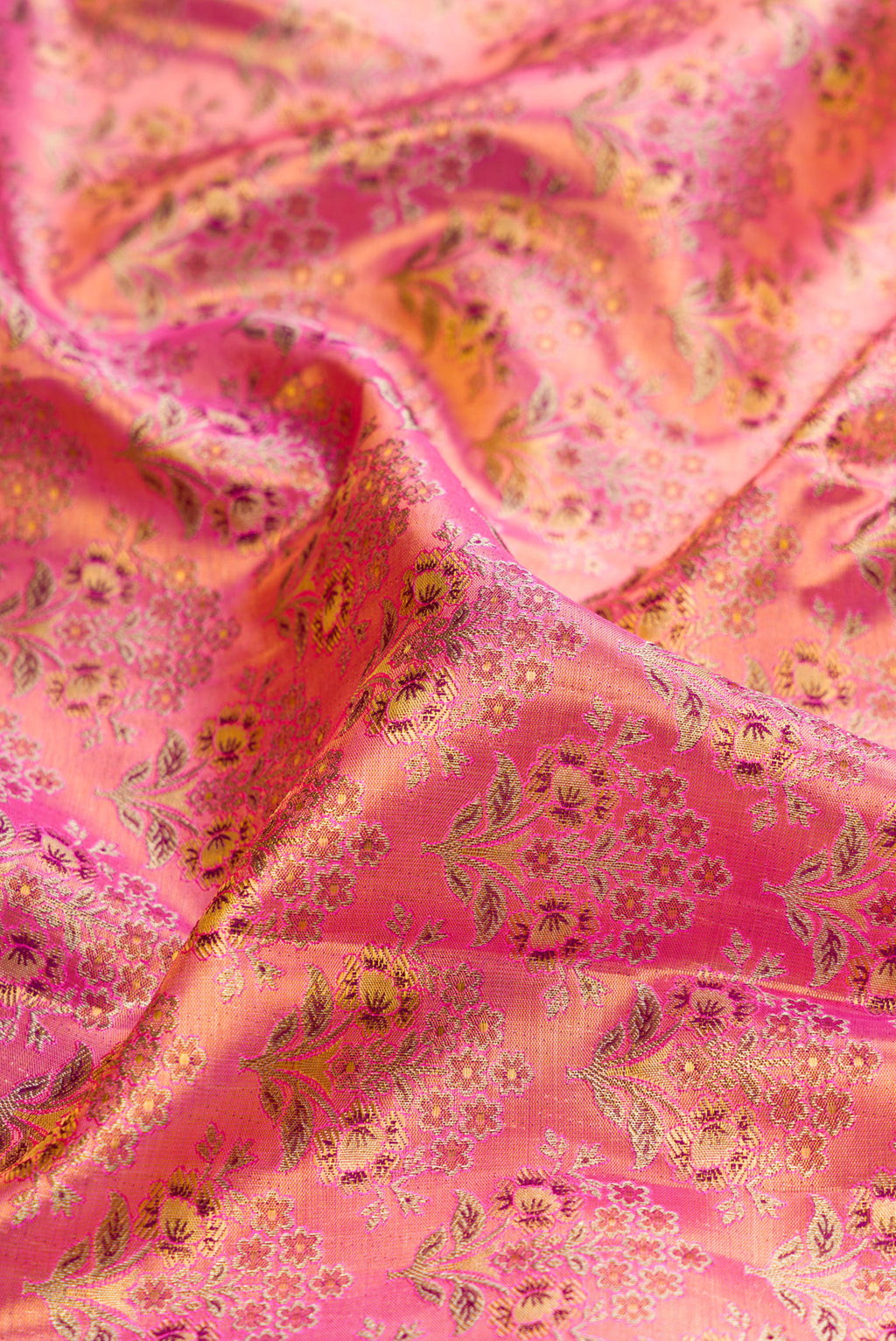 Close up of Pink Dual Tone Kanjivaram Tissue Silk Saree with Zari Brocade on the body and Fancy Border.  displaying folds
