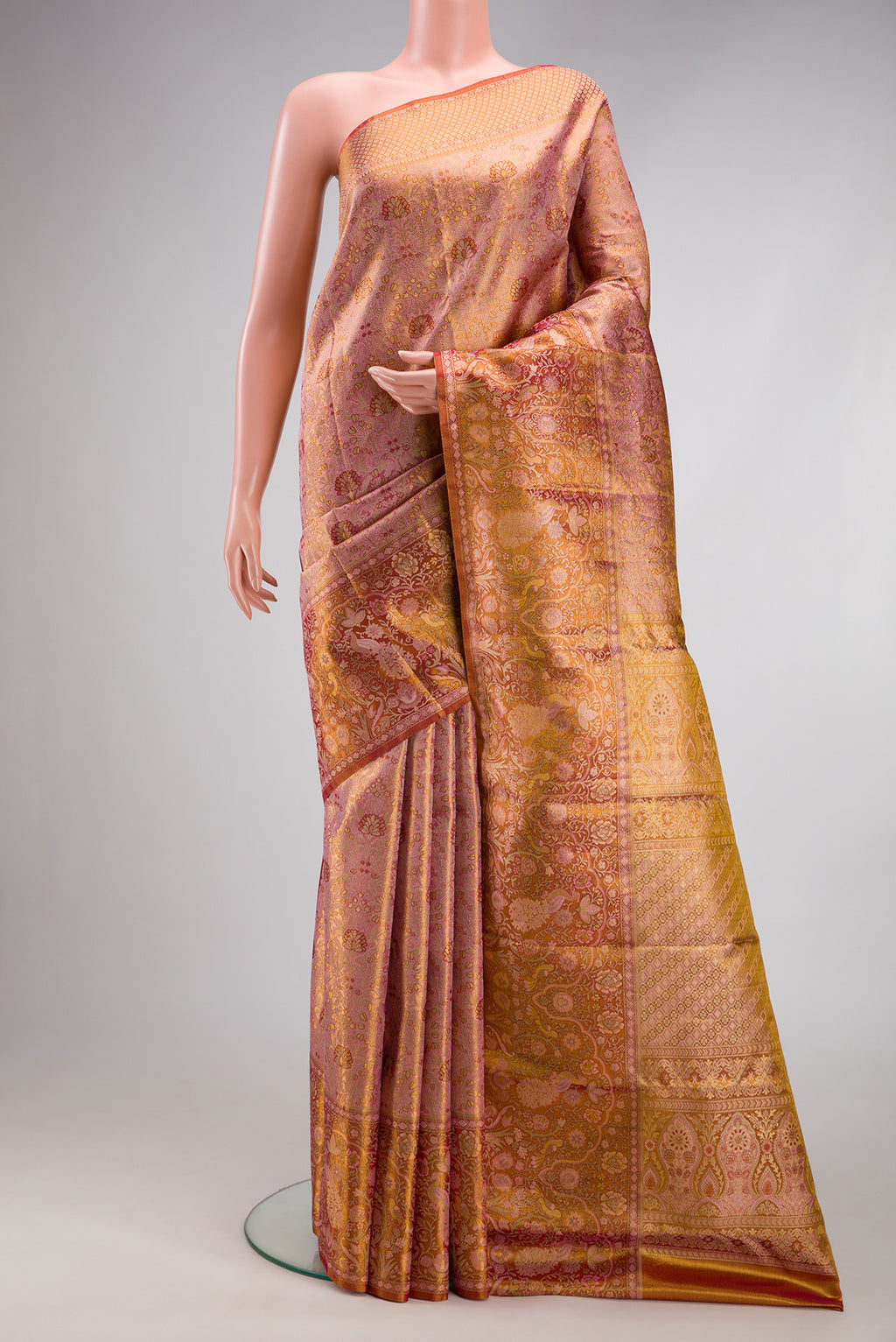 Rose Gold Dual Tone Kanjivaram Tissue Silk Saree with Zari Brocade on the body and Fancy Border.  displayed on a mannequin