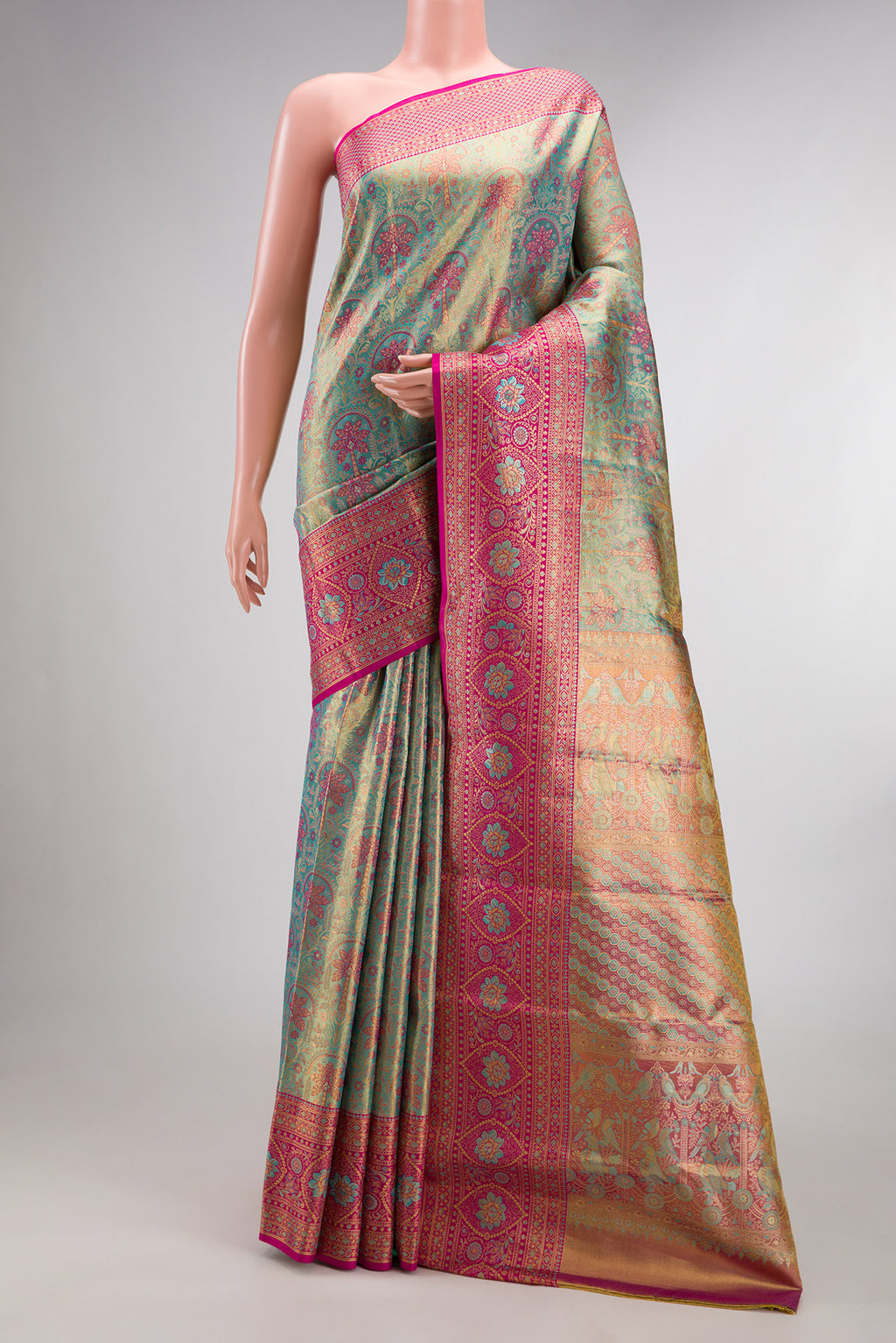 Sea Green Dual Tone Kanjivaram Tissue Saree with Zari Brocade on the body and Fancy Border.  displayed on a mannequin