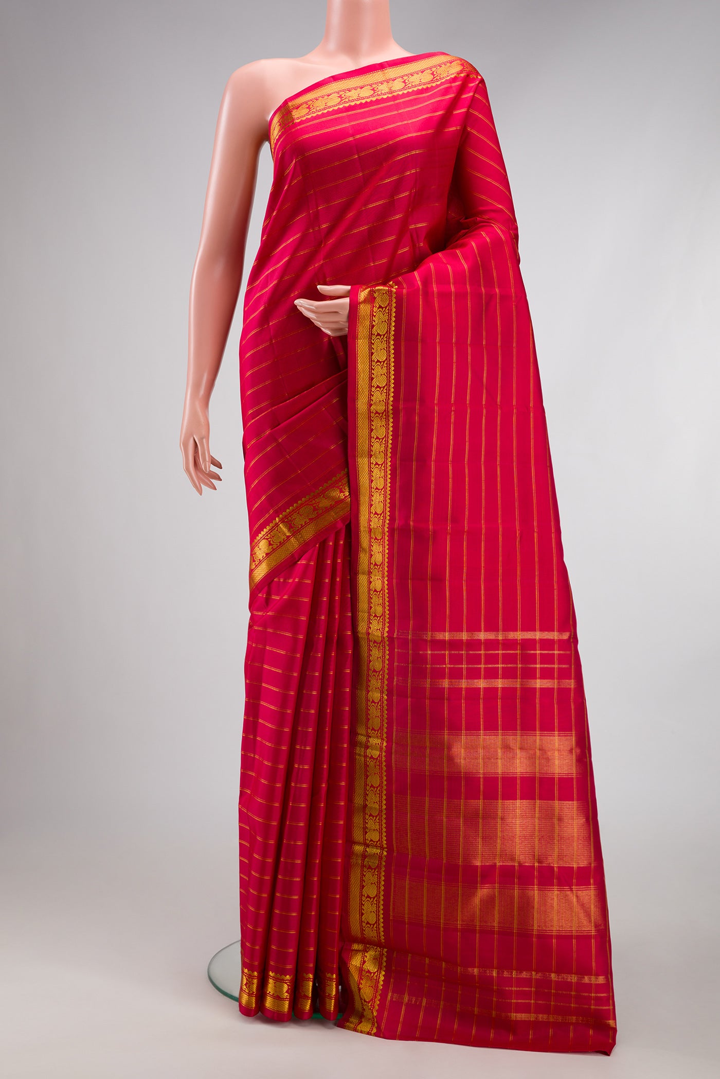 Maroon Kanchipuram Silk Saree with Stripes on the body and Zari Border.  displayed on a mannequin