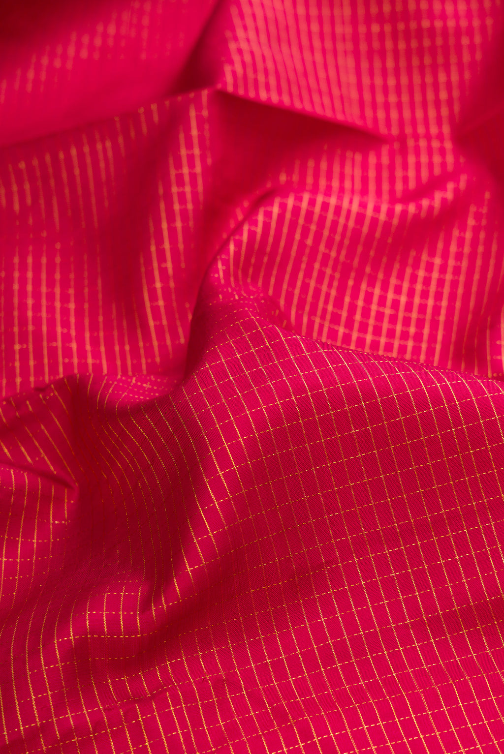 Close up of Pure Silk Maroon Kanchipuram Saree with Checked design on the body and Zari Border.  displaying folds