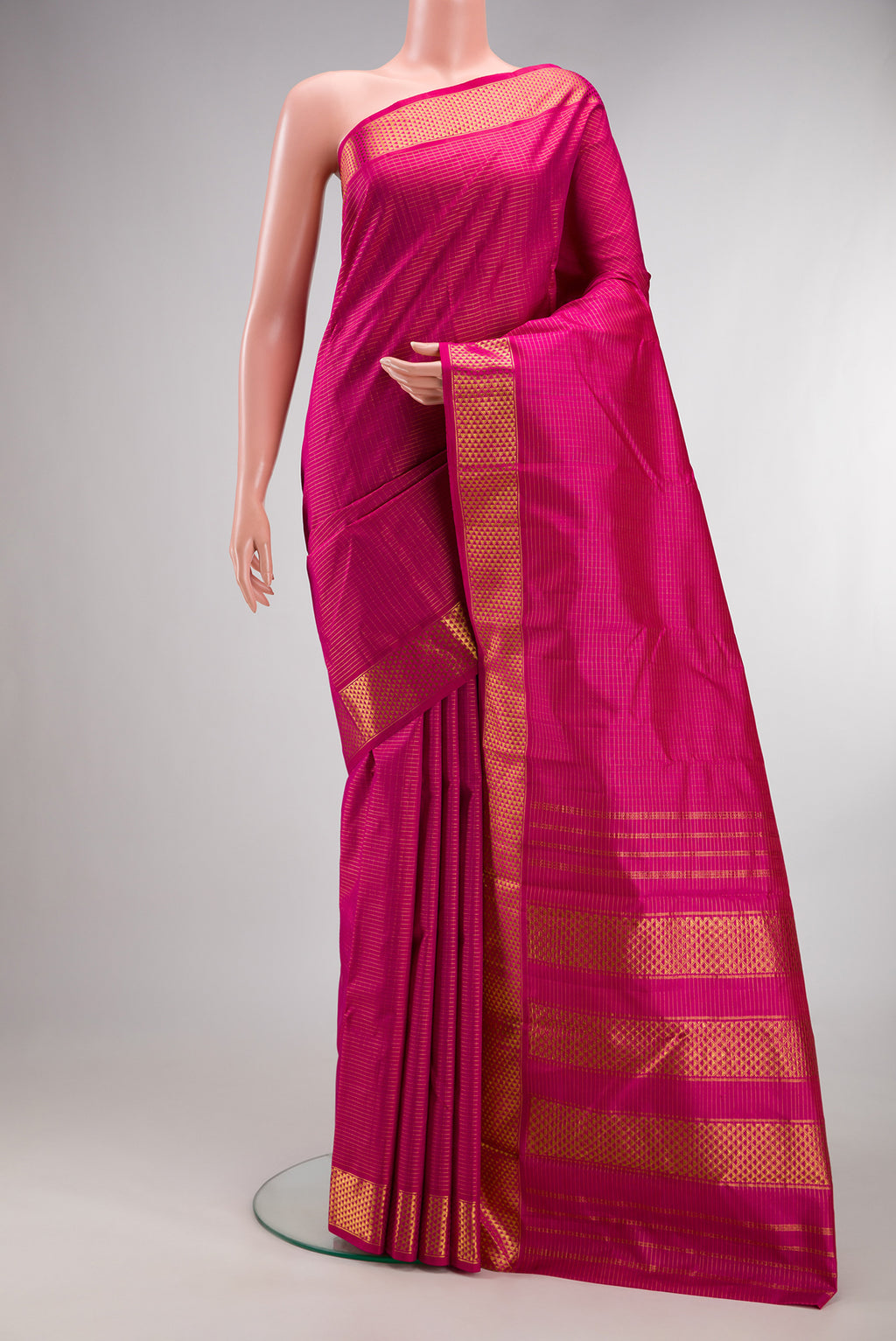 Pure Silk Rani Pink Kanchipuram Saree with Checked design on the body and Zari Border.  displayed on a mannequin