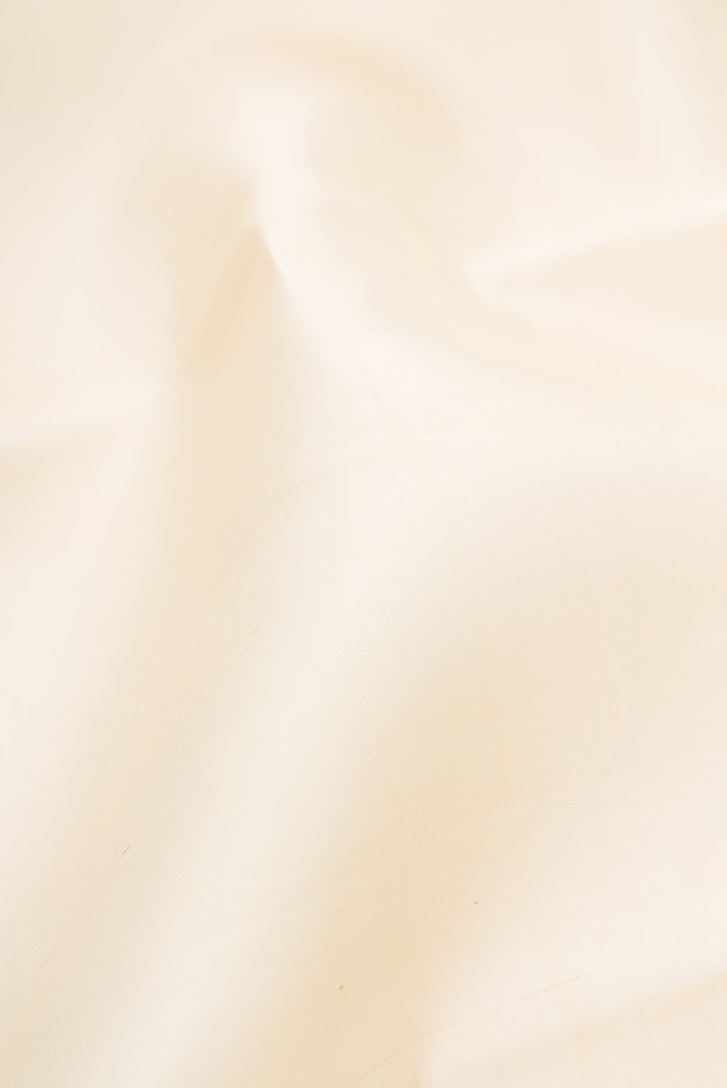 Close up of Off White Kanchipuram Silk Saree with Plain Body and Temple Border.  displaying folds