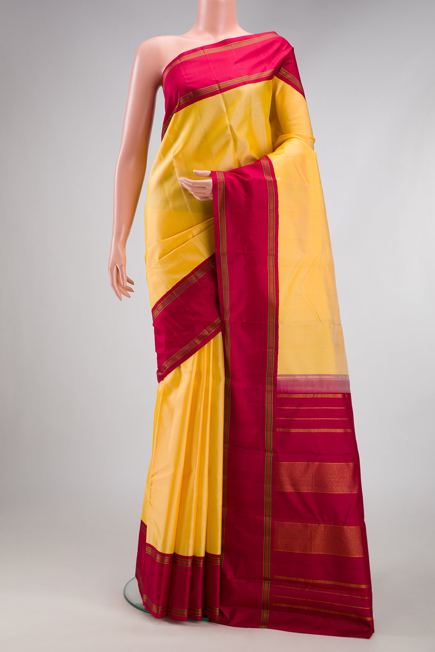 Yellow Kanchipuram Silk Saree with Plain Body and Plain Border.  displayed on a mannequin