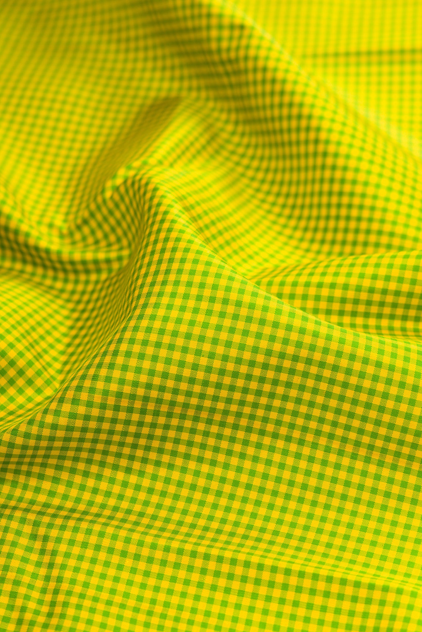 Close up of Parrot Green Kanjivaram Silk Saree with Checked design on the body and Zari Border.  displaying folds