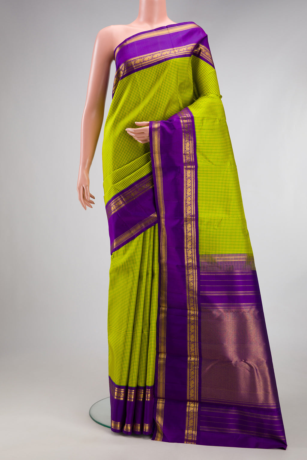 Parrot Green Kanjivaram Silk Saree with Checked design on the body and Zari Border.  displayed on a mannequin