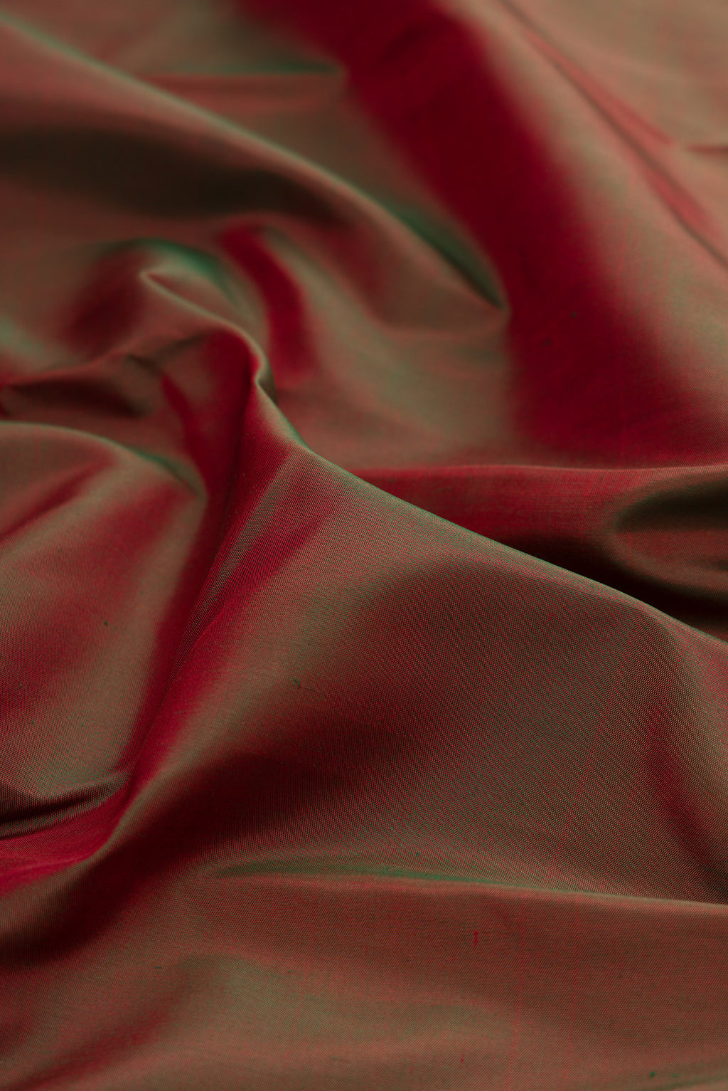 Close up of Mehandi Green Dual Tone Kanjivaram Silk Saree with Plain Body and Temple Border.  displaying folds