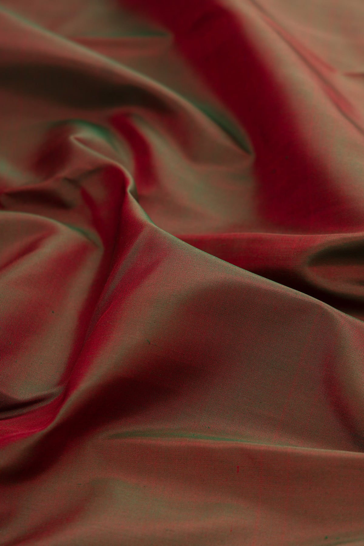 Close up of Mehandi Green Dual Tone Kanjivaram Silk Saree with Plain Body and Temple Border.  displaying folds