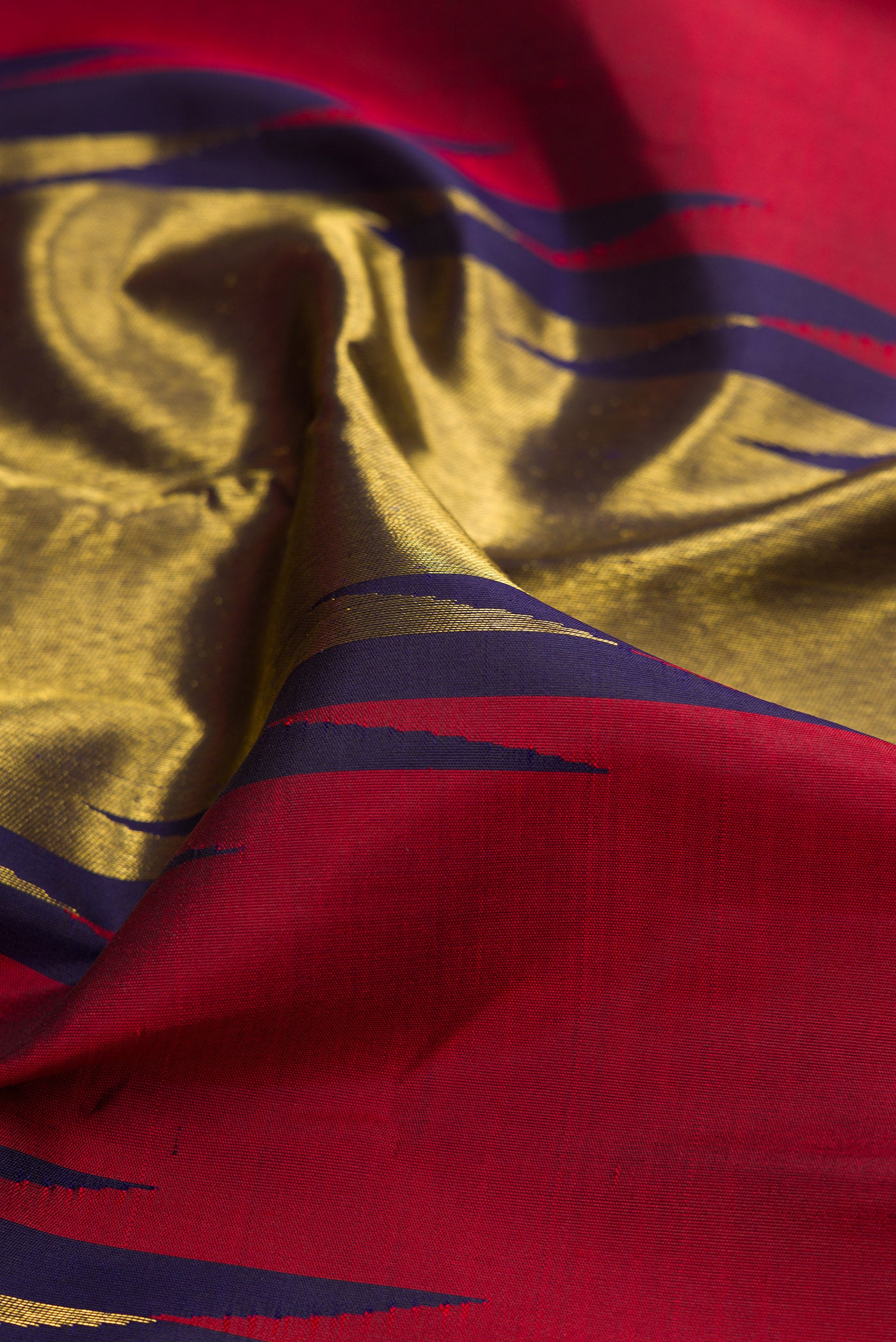 Close up of Maroon Kanjivaram Silk Saree with Plain Body and Temple Border.  displaying folds