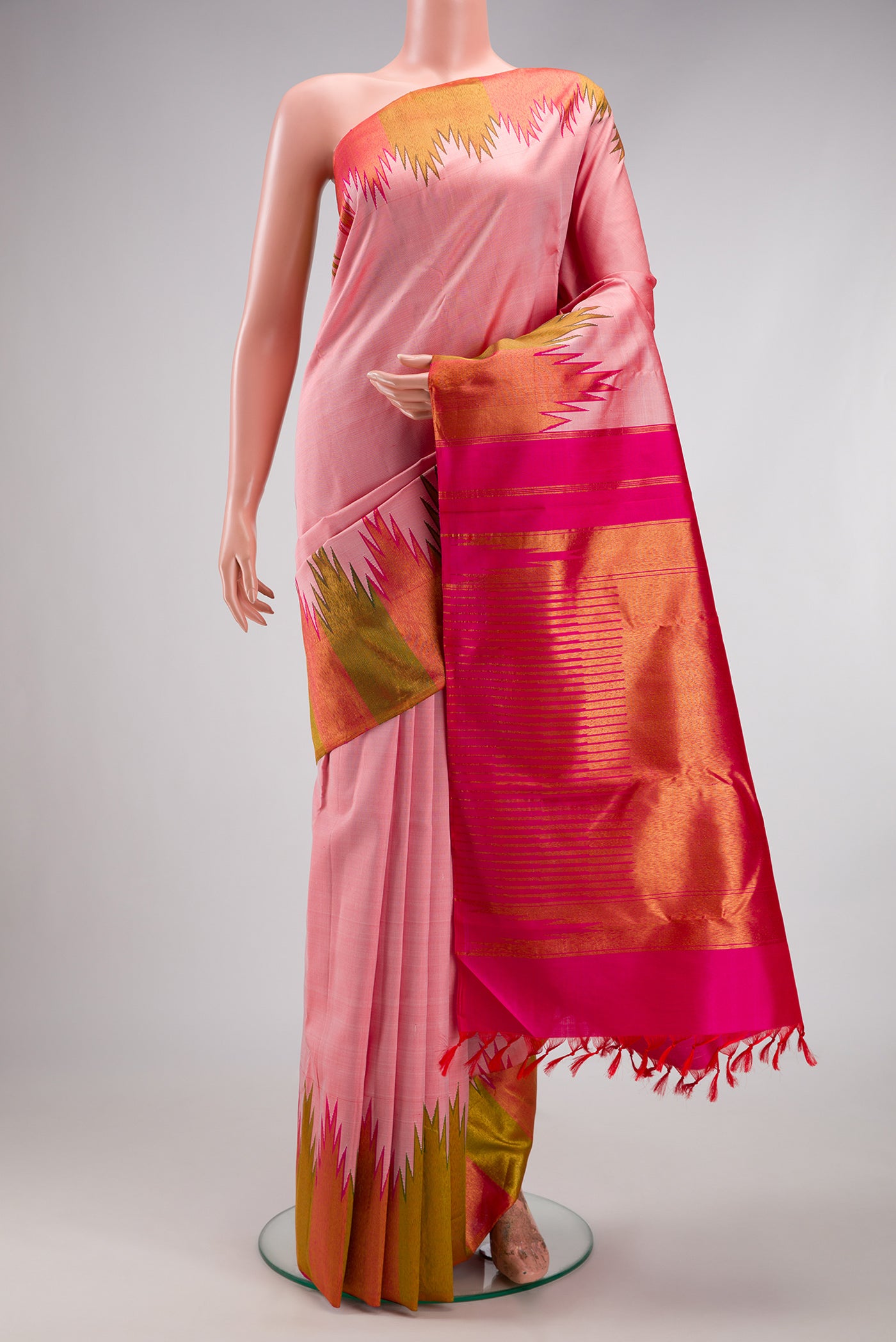 Rose pink Kanjivaram Silk Saree with Plain Body and Temple Border.  displayed on a mannequin