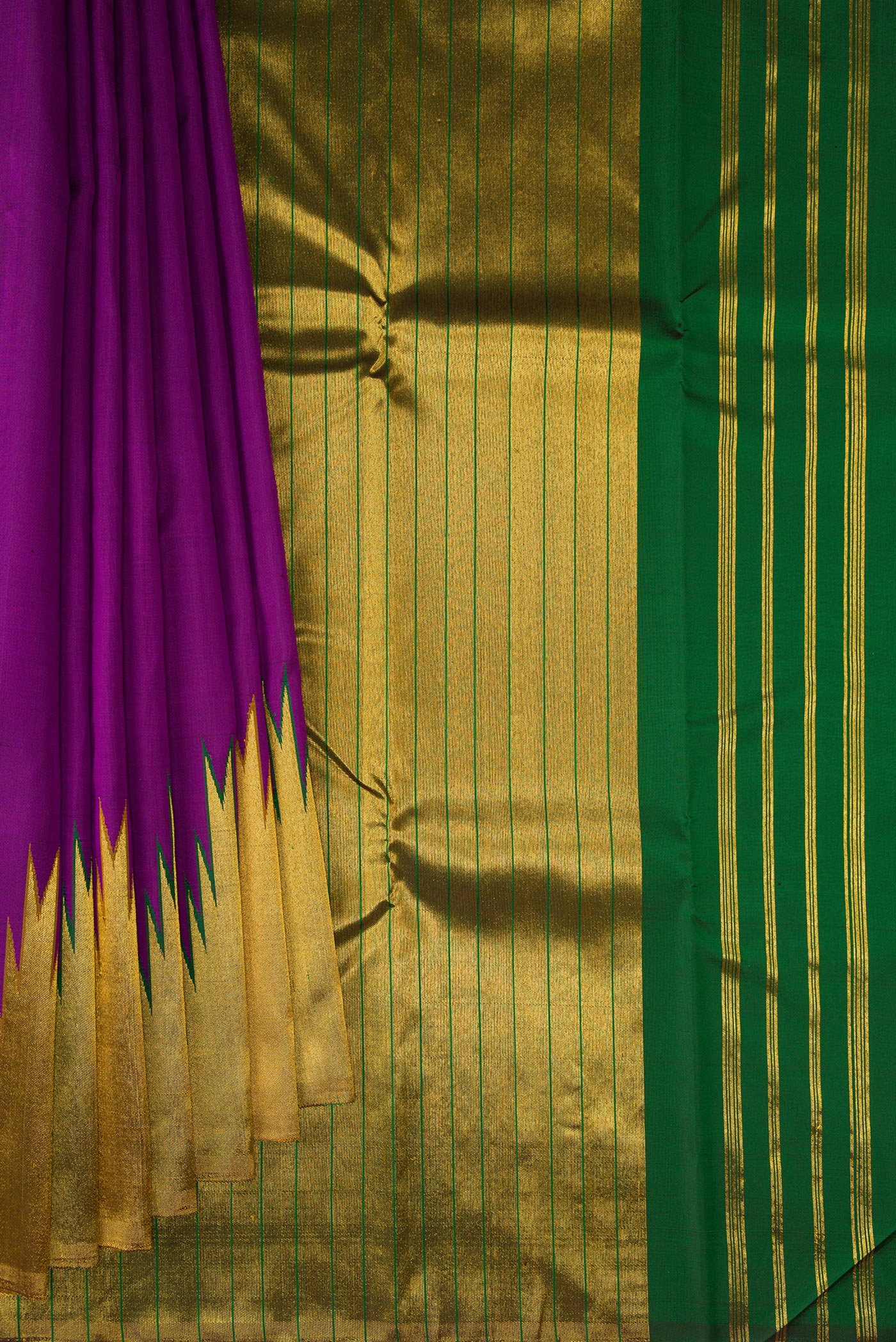 Pleats and pallu of Purple Kanjivaram Silk Saree with Plain Body and Temple Border. 