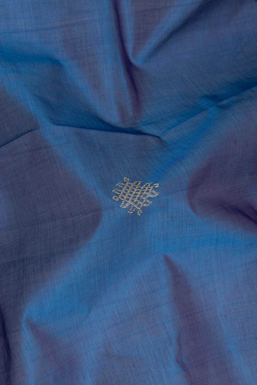 Close up of Peacock Blue Silk Cotton Saree with Zari Butta on the body and Zari Border.  displaying folds