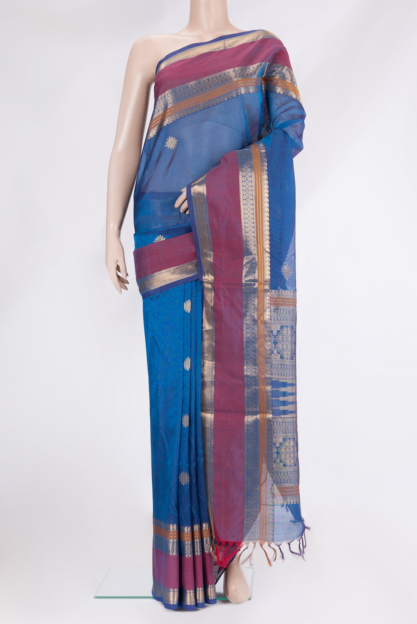 Peacock Blue Silk Cotton Saree with Zari Butta on the body and Zari Border.  displayed on a mannequin