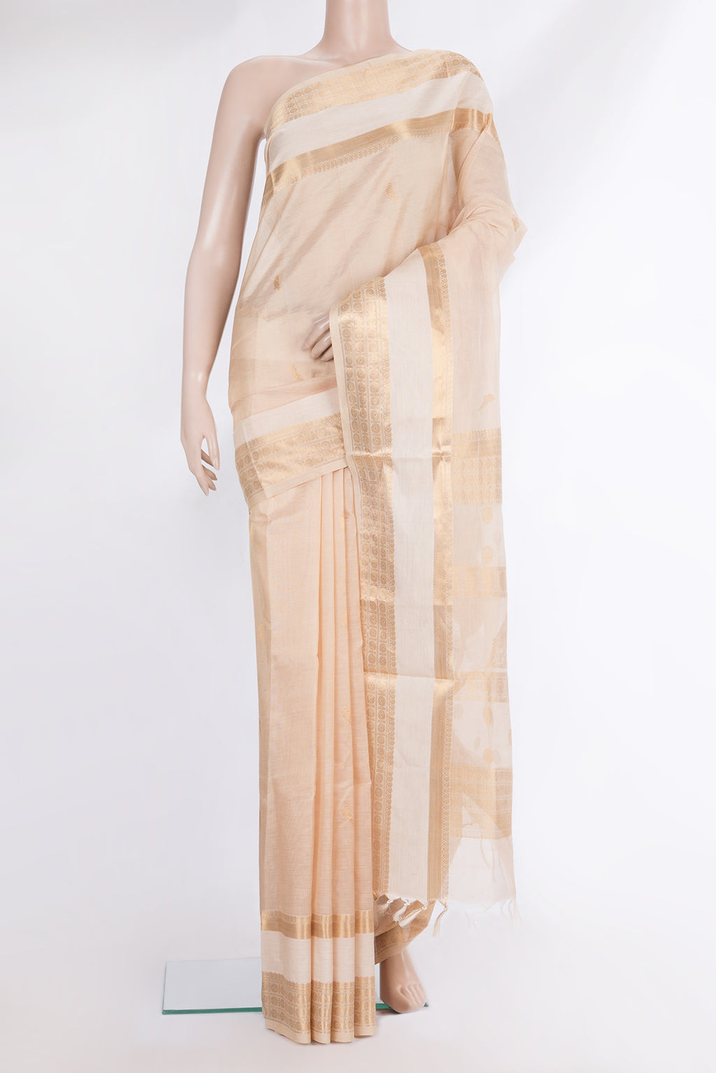 Beige Silk Cotton Saree with Zari Butta on the body and Fancy Border.  displayed on a mannequin