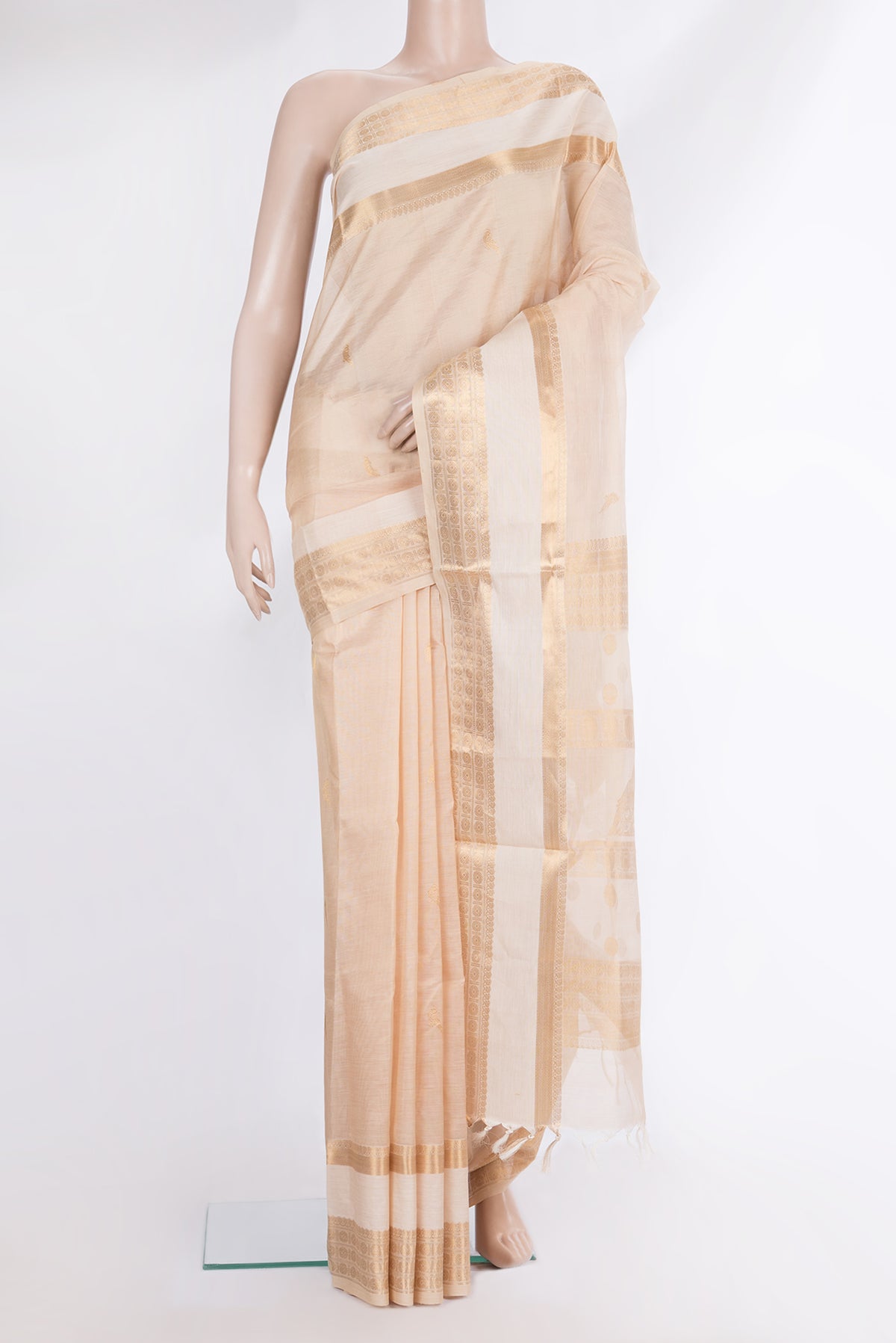 Beige Silk Cotton Saree with Zari Butta on the body and Fancy Border.  displayed on a mannequin
